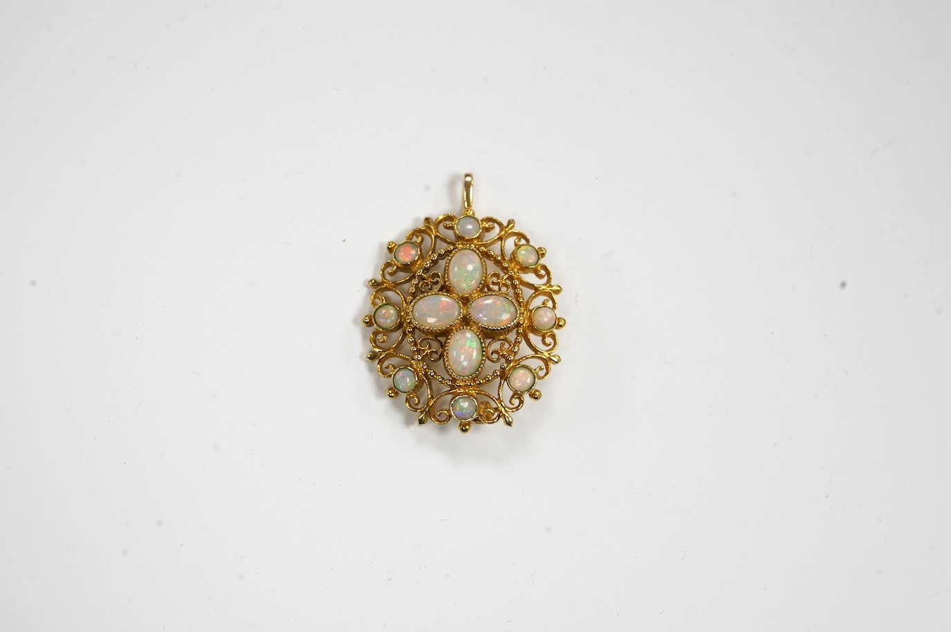 A modern 9ct gold and white opal cluster set oval pendant brooch, 33mm, gross weight 8.7 grams. Condition - fair to good